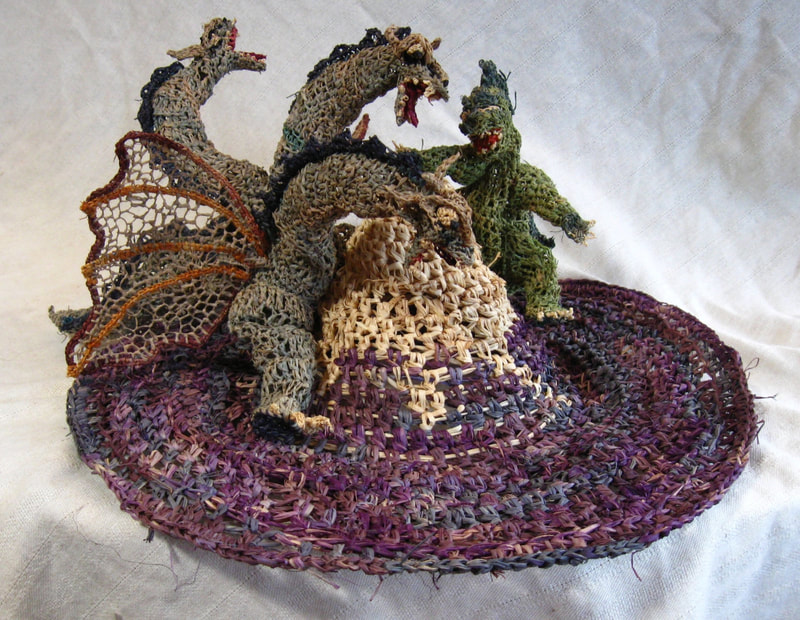 Godzilla v. Ghidorah on Mt. Fuji Hat, crocheted raffia by C. Buffalo Larkin